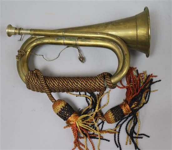 A brass bugle, a cast iron lion and various candlesticks